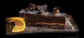 of warm chocolate ganache & vanilla ice cream Vegan Chocolate Cake.