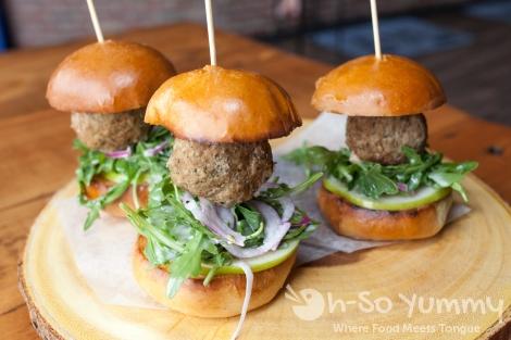 Meatball Sliders (3/$10) - meatballs stuffed with mozzarella cheese and braised in a white wine jus, served with green apple, fennel and arugula slaw on a brioche bun This came with a large meatball