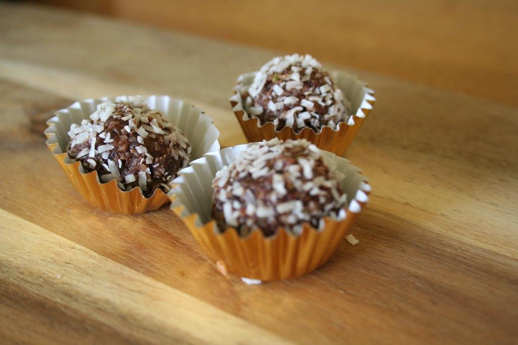 Orange Choc Balls 20 pitted dates 1 cup cashew nuts 2-3 tablespoons cacao powder ¼ teaspoon orange essence Dessicated coconut for rolling Ready in 10 minutes Serves 20 balls bru 1.