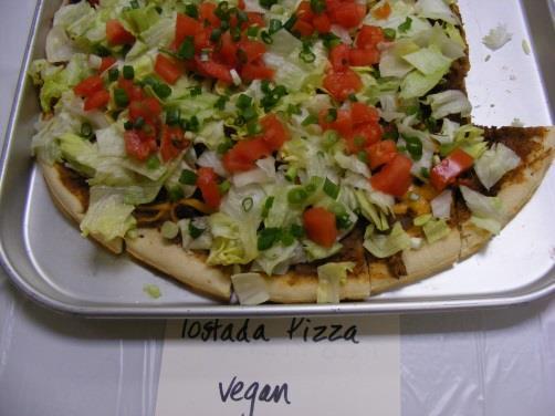 Tostada Pizza 1 can refried beans 1 can black beans 1 cup salsa 1 package light house meatless Mexican crumbles 1 4oz package rice cheese Lettuce Tomatoes Green onions Makes two 12 pizzas.