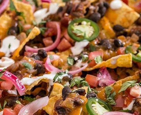 Beans Nachos Ingredients 1 can refried beans 1 large avocado chopped 1 bag tortilla chips 3 green onions chopped 3 roman tomatoes diced I pkg. cheese substitute 2 tbsp. Silk milk 1 tbsp.