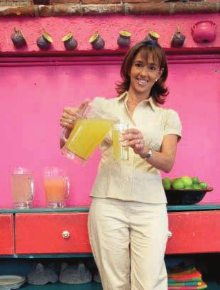 A woman is making fresh fruit shakes.