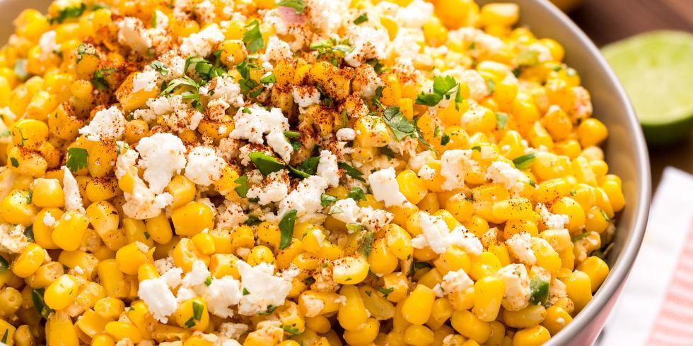 MEXICAN CORN SALAD 6 ears corn, kernels stripped 1/2 c. mayonnaise 1/4 c. cotija cheese or feta, plus more for garnish Juice of 2 limes 2 tbsp. chopped fresh cilantro, plus more for garnish 1 tbsp.