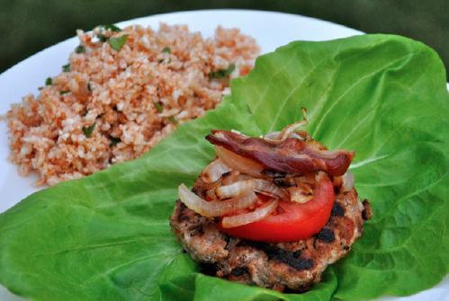 Fully Loaded-Lettuce Wrapped Turkey Bacon Burgers Ingredients (Makes 6 Servings): 8 strips nitrate free bacon ½ yellow onion, sliced 1/8 cup blanched almond flour 1 pound organic ground turkey 2 tsp