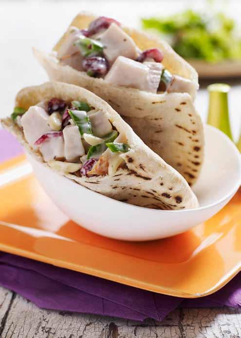 Cape Cod Turkey Pitas MAKES 8 servings PREP 10 minutes CHILL 1 hour 1 slice deli smoked turkey, cut ¾ inch thick (about 1 lb) ½ cup light ranch dressing ⅓ cup sliced, blanched almonds ⅓ cup Craisins,