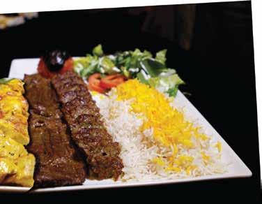 a skewer of juicy mixedminced lamb and beef cooked over open fire and served with grilled tomato