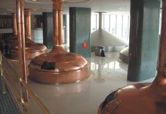 Photo: Roger Putman. Figure 2: Pilsner Urquell brewhouse (2004). Note the copper clad vessels with one of two 10m lauter tuns in the back ground.