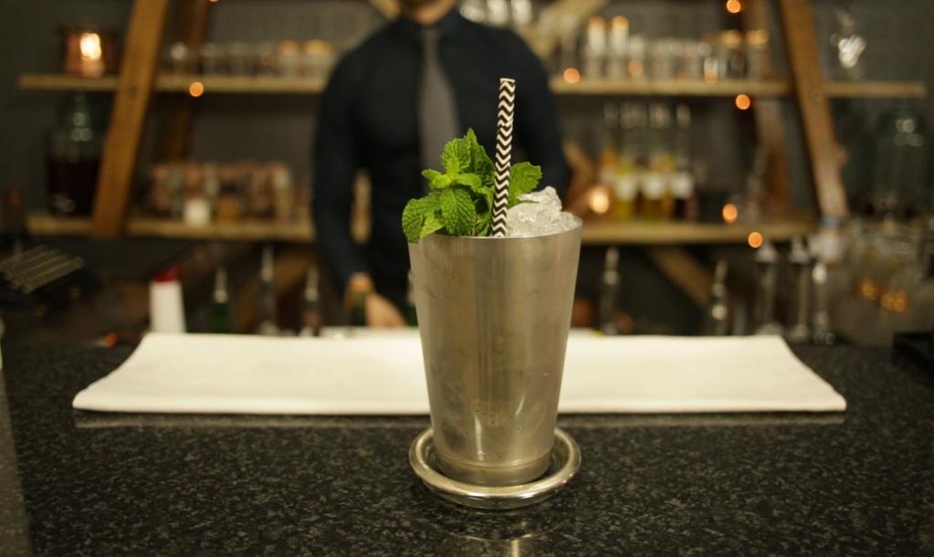 THE MINT JULEP In a metal mug, add one measure of sugar syrup. Add one large handful of fresh mint leaves. Using the back of the bar spoon or a muddler, gently crush the mint leaves.
