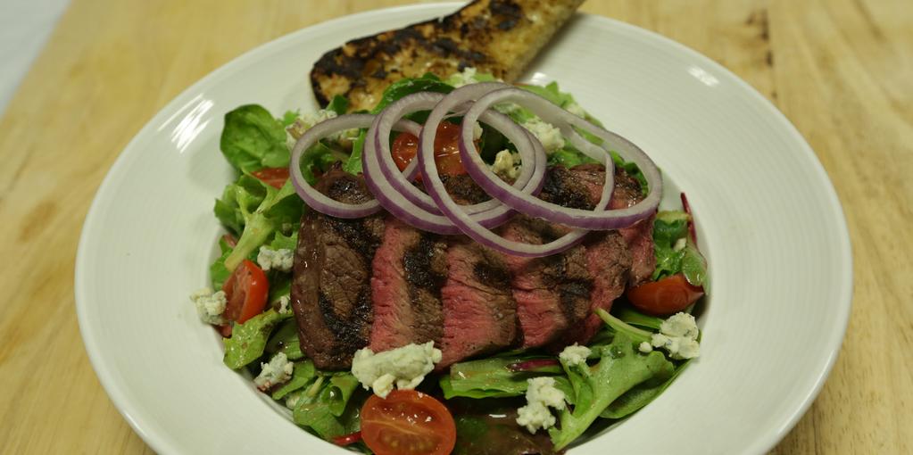 Grilled Sirloin Salad 1 x 5 oz. top sirloin 2 pinches salt and pepper mix 3 oz. spring mix 1 oz. crumbled blue cheese 2 fl. oz. balsamic vinaigrette 3 grape tomatoes, halved 5 thinly sliced red onion rings 1 grilled ciabatta slice Tongs Chef s knife Cutting board Large pasta bowl 2 oz.