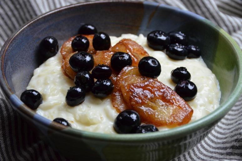 Rice Pudding with Caramelized Bananas and Blueberries 2½ cups half and half 2½ cups milk 1 tablespoon butter ½ cup sugar 1 cup long grain white rice 1 cinnamon stick 1 teaspoon pure vanilla extract