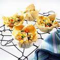 CRANBERRY CHICKEN CUPS 6 sheets filo pastry 3 chicken breasts 1 tblspn cranberry sauce 3 tblspns crème fraiche 2 spring onions ½ tspn grated lemon rind Fresh coriander Lemon zest Preheat oven to 200