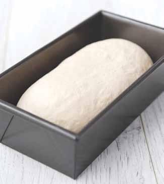 Gently knead the dough for a couple of minutes; this knocks it back and deflates it. It should be much, much softer and more elastic than before. Flatten the dough out into a rough rectangle.