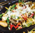 00 STEAK FAJITAS Marinated lean steak grilled with mushrooms, green peppers, red peppers and onions, topped with melted cheese.