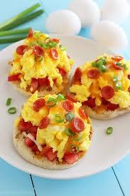 Breakfast Pizzas 4 eggs, beaten 1/3 cup pizza sauce 2 English muffins, split 1/2 cup shredded cheese Optional toppings: pepperoni, ham, green onions, tomatoes Heat
