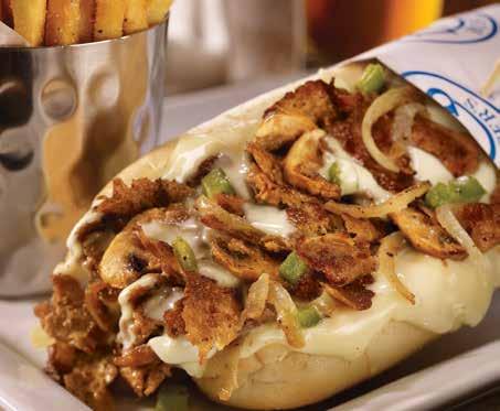 The Philly Cheesesteak Shaved ribeye on a warm hoagie roll topped with cheese and served with french fries.
