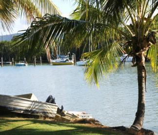 With stunning views overlooking Port Douglas Dickson Inlet, the Coral Sea and Daintree Mountains, palms silhouetted against a tropical sky and yachts gently bobbing in the calm waters below, the Port