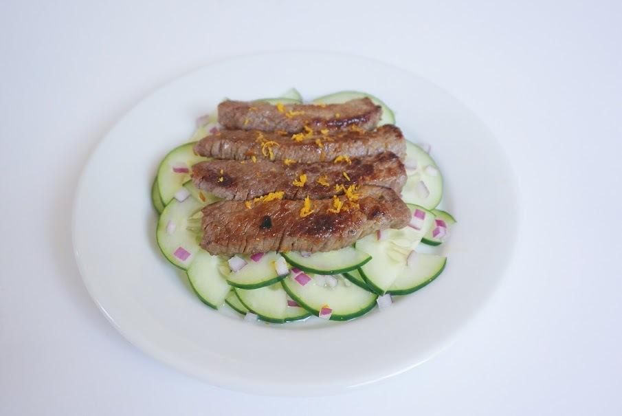 Cucumber Salad with Beef Ingredients 1/2 cucumber 2 tablespoons diced red onion 2 tablespoons white vinegar 1 teaspoon coconut oil 1/2 pound sir fry beef 1/4 teaspoon orange zest Instructions 1.