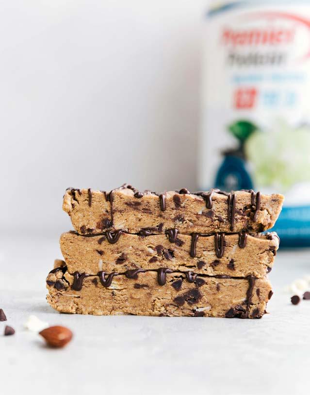 SNACKS ALMOND COCONUT PROTEIN BARS 10-12 SERVINGS 1 HR & 10 MINS MICROWAVE POWDER 3/4 cup almond butter 2 tbsp + 1/2 tsp coconut oil, separated 4 tbsp honey 2 tsp vanilla extract 1/4 tsp salt 2/3 cup