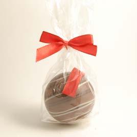 white and red chocolate design. In transparent bag, tied with red bow.