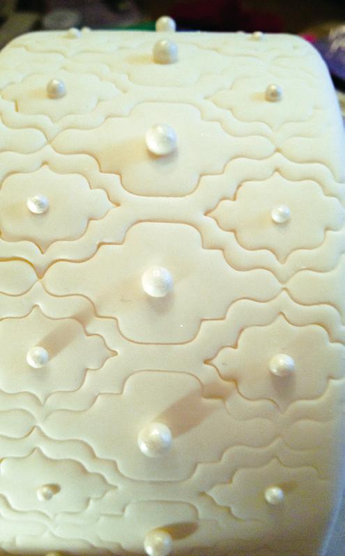 Immediately, emboss the 3 layer with the Quatrefoil Cutter while fondant is still fresh to prevent cracking. Set aside.