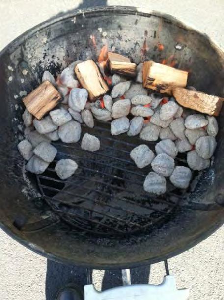 The goal is to have most of the heat in the rear of the kettle grill. When using a stone add a small amount of charcoal directly under the stone as well.