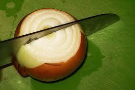 4. Cut the onion in half through the middle a. Stand the onion on its side so that it sits on one of the flat ends you just made. b.