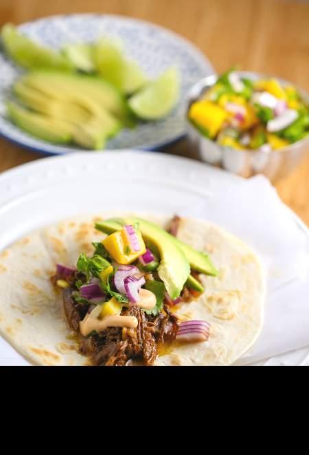 Shredded Tropical Beef Tacos. These tacos come together with bright and tropical flavors while simmering in a slow cooker.