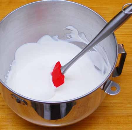 Meanwhile, warm the cream. Remove the syrup from the heat and continue stirring as you add the cream. Careful, it will boil up. Stir, stir, stir.