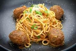 tomato sauce, served with beef and pork meat balls, topped with grated