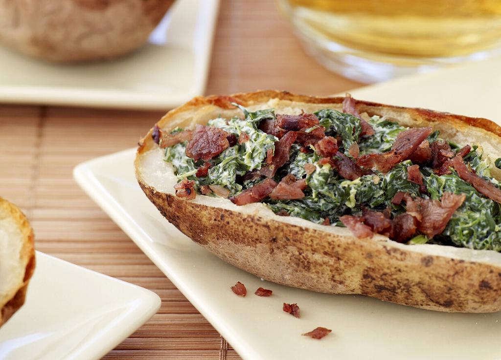 BAKED POTATO SKINS WITH SPINACH AND BACON Creamy spinach and salty bacon makes these potatoes a hit. Make a double batch for your next party.