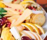 ARTISAN CHEESE TRAY Selection of delicious artisanal cheeses with dried fruit, nuts and crackers artistically arranged on a