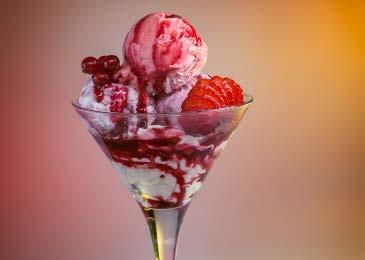 Two scoops of cheescake gelato, one scoop of strawberry gelato, strawberry and vanilla toppings, fresh fruits,