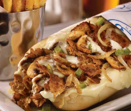 handhelds CHEESE-CRUSTED STREET TACOS YOUR CHOICE OF GREEN CHILE CHICKEN OR ANCHO PORK CARNITAS Cheese-crusted flour tortillas stuffed with your choice of smoked, pulled green chile chicken