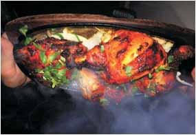 aromatic Chicken Balti Plaza Chicken tikka cooked together with tandoori king prawns, fresh chillies in fairly hot spices and herbs. Garnished with fresh coriander.