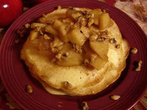 Apple Pancakes with Maple Crusted Walnuts We took some good Fuji apples and peeled and sliced them.