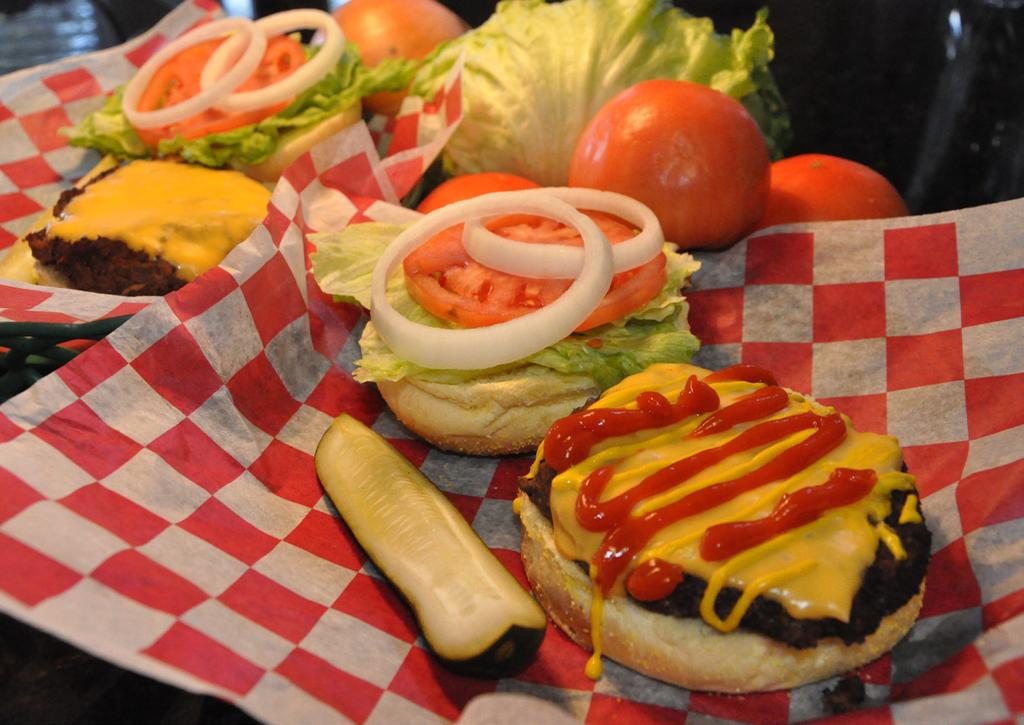 99 Burger and Hotdog Combination with assorted toppings, condiments, pickles, 2 traditional sides, tea, ice and paper goods. $11.99/$10.99/$9.