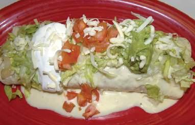 Served with lettuce, sour cream, tomatoes and guacamole - 8.99 A 10" flour tortilla stuffed with seasoned grilled chicken, steak and five shrimp then covered with cheese sauce - 11.