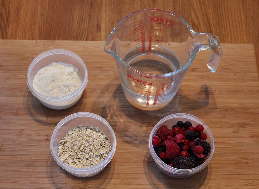 Put the protein powder and berries into a blender.