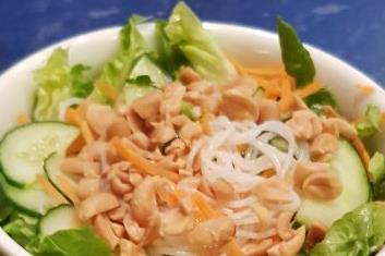 Salad with Rice Noodles and Peanuts 1 l water 100g thin rice noodles ½ salad ½ cucumber 2 small carrots 1 lime 4 tbsp sesame oil ½ tsp chili flakes ½ tsp salt ¼ tsp pepper 2 handfuls of peanuts Heat