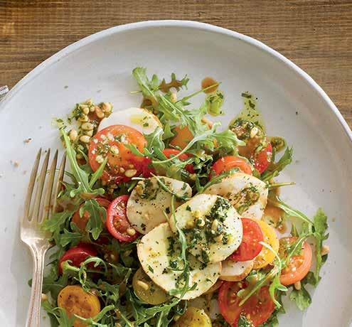 SMOKED CAPRESE SALAD A new twist on a classic combines smoked fresh mozzarella with heirloom cherry tomatoes and arugula, drizzled with pesto and Hellmann s Balsamic Vinaigrette, and seasoned with