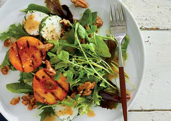 SWEET HEAT PEACH & GOAT CHEESE SALAD A perfect summer salad topped with juicy grilled peaches, herbed goat cheese, and walnuts spiced with brown sugar and cayenne.