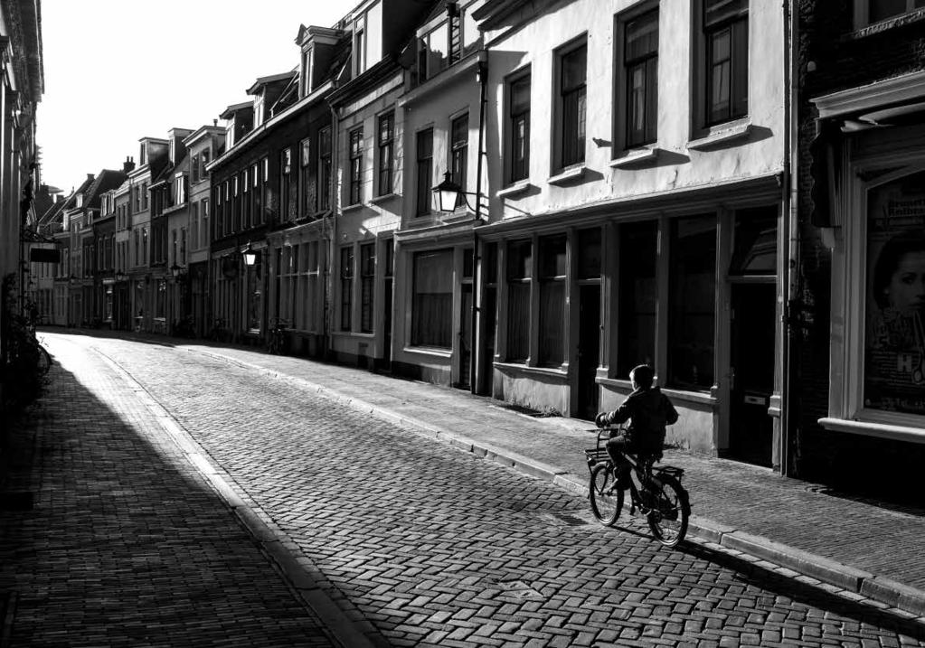 Image taken in Utrecht from Oudegracht, looking in the direction of Springweg. The boy bikes on Haverstraat.