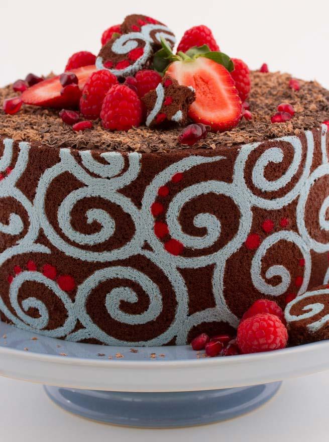 Chocolate mousse cake Rich and creamy layers of dark chocolate mousse fill this dessert cake which is encased in an almond sponge collar. Grated chocolate and fresh berries complete the decoration.