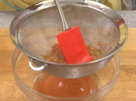 4 4 Using a spatula, push the juice (which has a lot of flavor) through strainer, capturing it in the bowl. Discard the seeds.