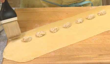 9 Place little nuggets of the filling, making them as large or small as you want (there is no traditional size when making agnolotti; it varies by region in Italy), arranging them in a line toward