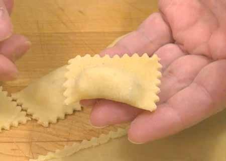 12 8 Here is one of the finished agnolotti. As you can see, it is folded along one edge and trimmed along the other three sides. This is traditional agnolotti.