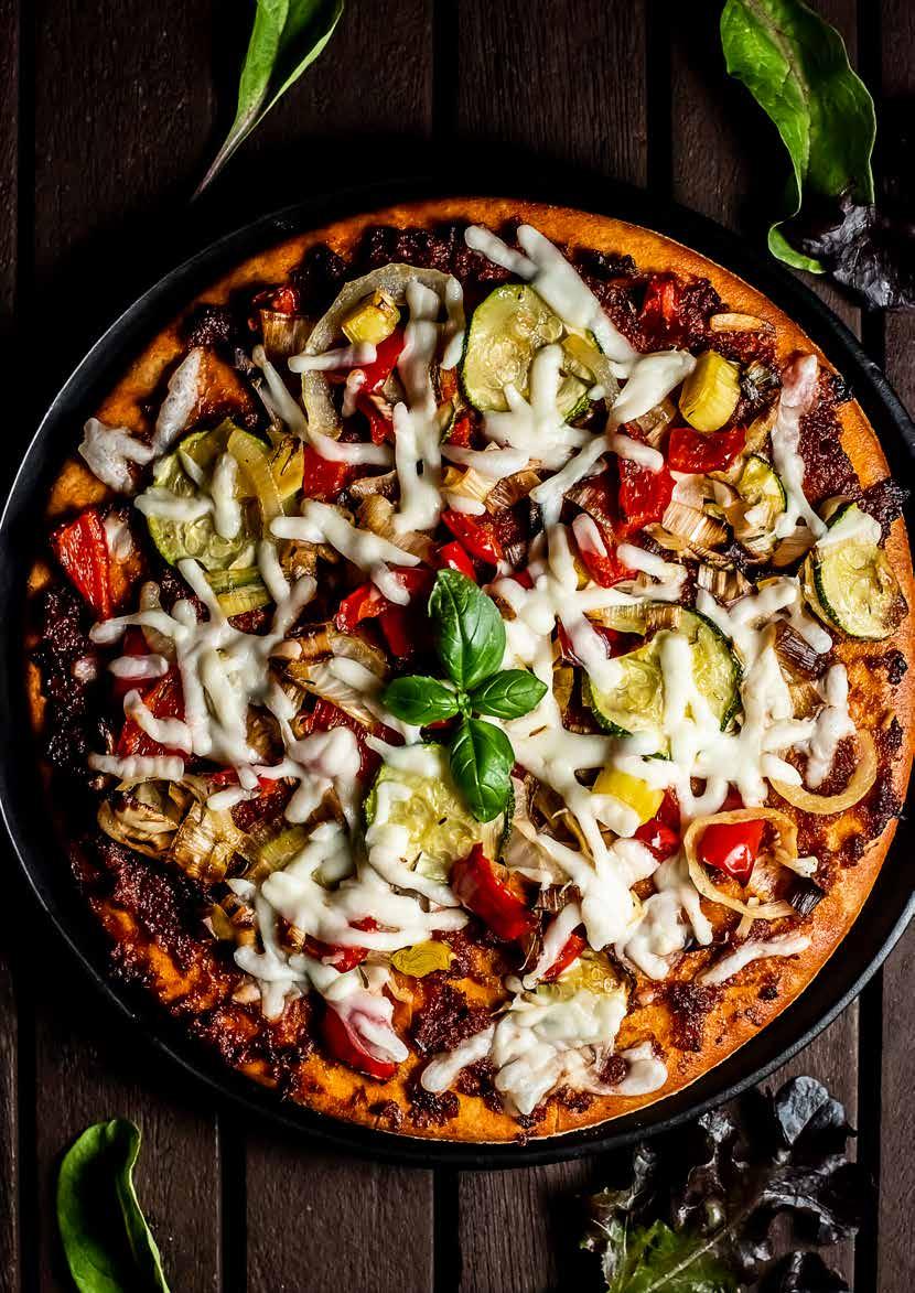 DINNER PIZZA AND SALAD 350g mixed vegetables 2 cloves garlic, peeled and crushed 1 tsp dried thyme 2 tbsp extra virgin olive oil 1 large vegan pizza base 1 tbsp sundried tomato paste 1 tomato, sliced