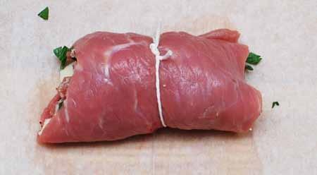 6 Roll up the meat, enclosing the filling, and tie with
