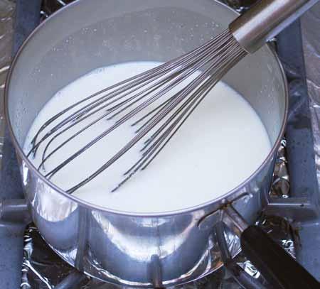 Add the warm milk to the polenta mixture, whisking to melt and disperse the chocolate and