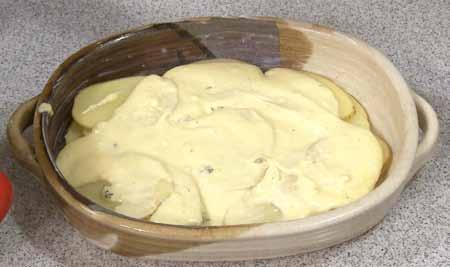 8 To assemble the dish, arrange about a third of the sliced potatoes on the bottom of a greased baking dish,